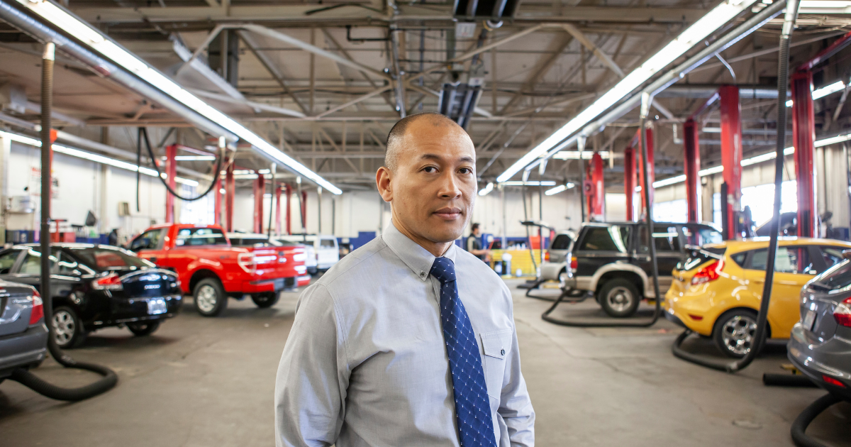 auto service manager standing in front of a service bay