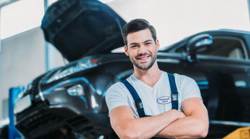 Workflow 360° Streamlines Auto Service Operations, Which Helps You Attract and Retain Skilled Technicians 4 auto-technician standing in front of a car with a smile